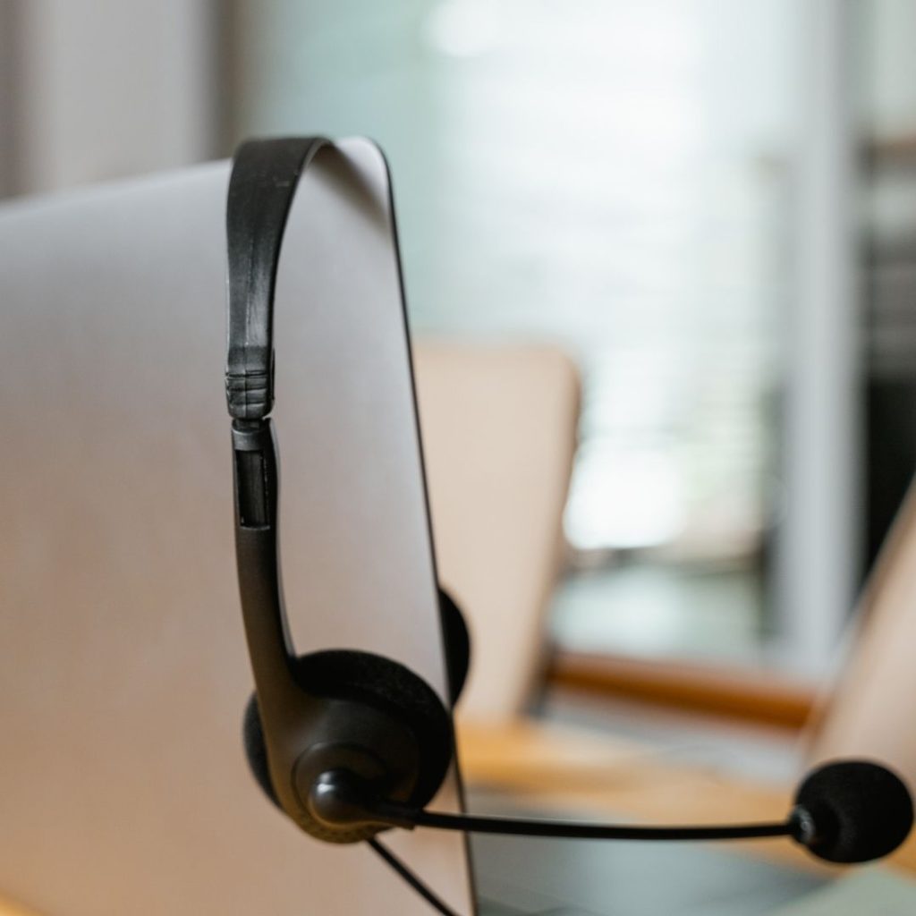a headset hanging on a laptop