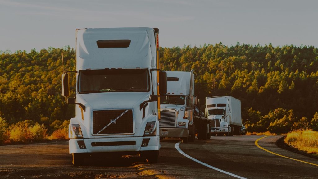 semi trucks parked along the road